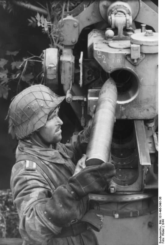 German soldier loading a shell into an 8.8 cm FlaK gun. (Pinterest via Twitter)