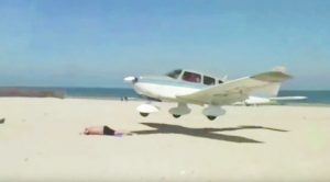 Pilot Nearly Misses Sunbather By Inches, Slams Into Fence