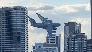 Massive Military Plane Flies Between Buildings