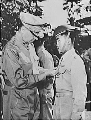 Manila, the Philippine Islands. In one of the last pictures to leave the Philippines before Manila fell to the Japs, General Douglas MacArthur (left) is shown pinning a Distinguished Service Cross on Captain Jesus A. Villamor, of the Philippine Air Force, for heroism in the air. In the center background is Lieutenant Jack Dale, of the U.S. Army.